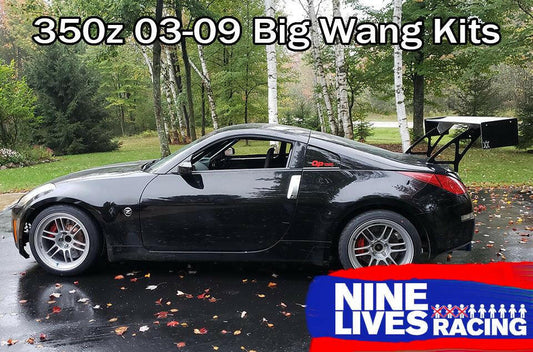 A black Nissan 350z with a large rear wing parked on a wet road surrounded by trees. The text above the car reads, "350z Big Wang Kit '02-08 Z33." Featuring extruded aluminum wings for superior GT3 performance. A blue and white logo at the bottom right corner says "9livesracing.