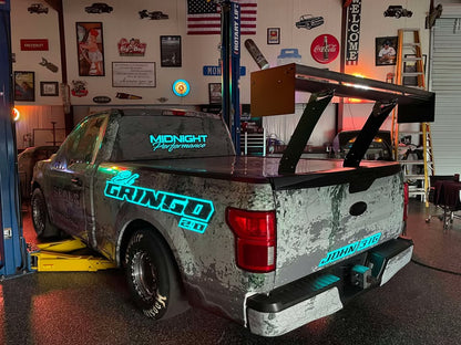 Ford F-150 with the Nine Lives Racing Big Wang Kit installed, showing a rear three-quarter view of the chassis-mounted aluminum rear wing.