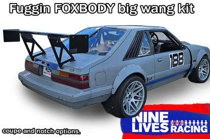 Rear view of a blue Ford Mustang with a large rear wing spoiler from Nine Lives Racing.