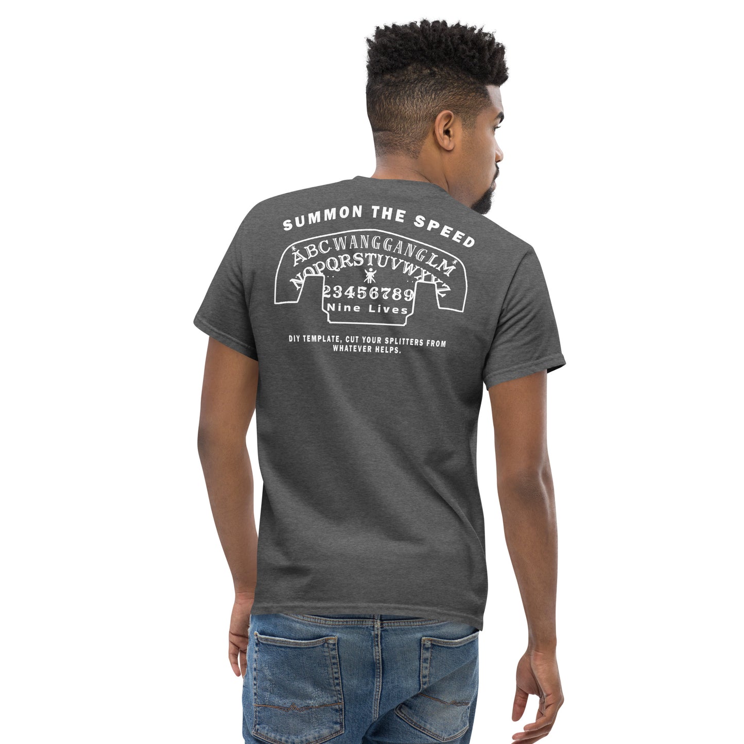 A person stands facing away, showcasing the back of their dark gray "Aerodynamics Is Witchcraft" T-shirt by Nine Lives Racing. This streetwear outfit features white text and graphics, including the phrase "Summon the Speed" at the top, an alphabet and number sequence, and the words "Nine Lives" followed by additional smaller text. Made from 100% cotton.