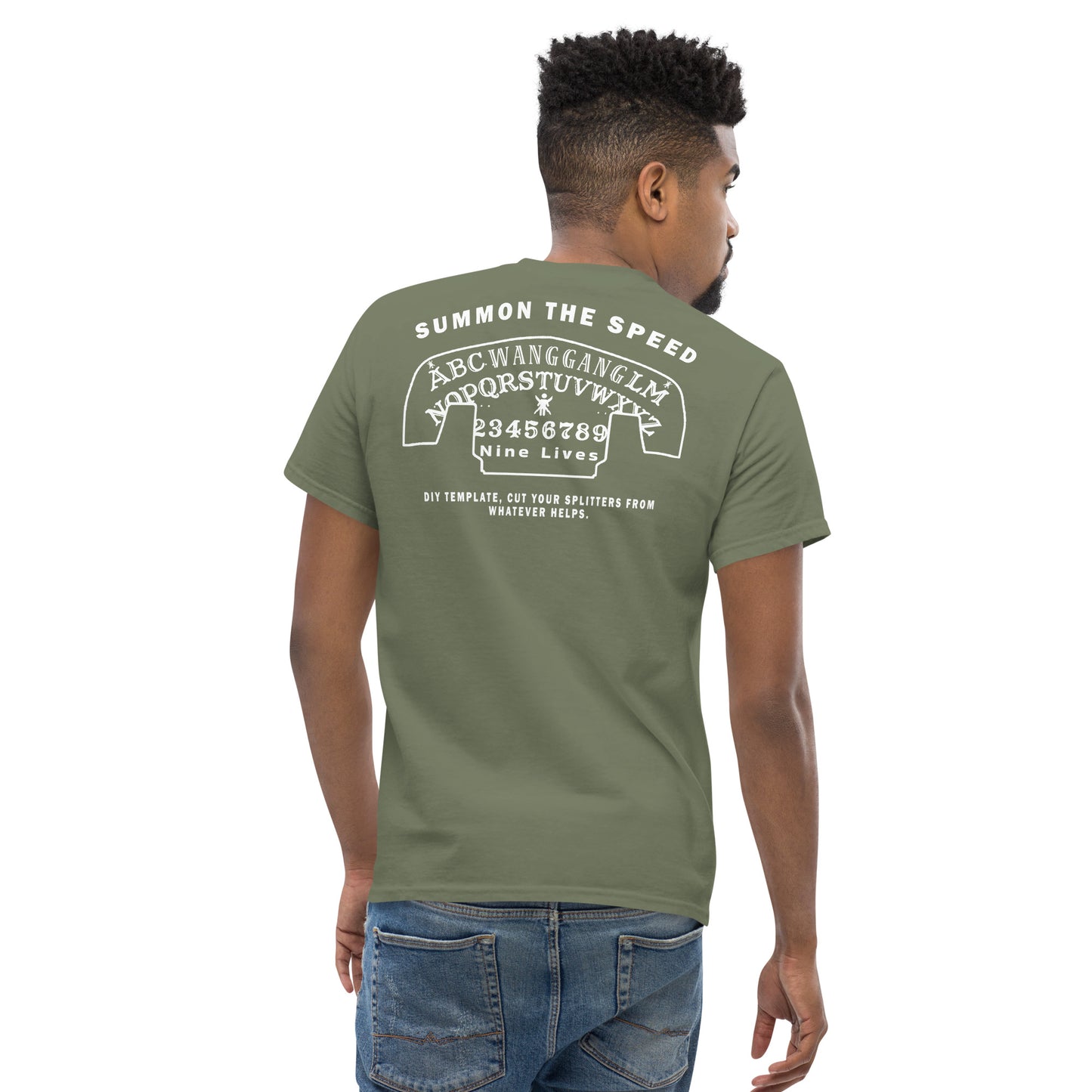 A person stands facing away from the camera, wearing a green Aerodynamics Is Witchcraft T shirt (ouija) from Nine Lives Racing. This 100% cotton men's classic tee features white text and designs on the back, including a stylized speedometer, alphabet, and numbers. The phrases "SUMMON THE SPEED" and "Nine Lives" are prominently displayed. The person has short hair—a perfect touch for streetwear outfits.