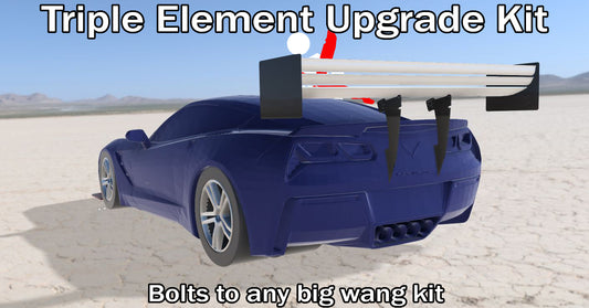 A blue sports car is showcased with a large rear wing outfitted with The Triple Element Kit from 9livesracing. At the top, text reads "The Triple Element Kit," and at the bottom, "Bolts to any big wang kit." This American-made enhancement boosts downforce. Behind the car, a vast desert stretches out under a clear sky.