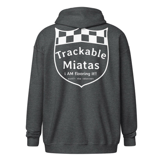 The Warm Wang Gang Zip up, a product by Nine Lives Racing, is a dark grey hooded sweatshirt featuring soft fleece lining. It showcases a racing shield design on the back with "Trackable Miatas" and "i AM flooring it!!" in white letters along with a checkered pattern at the top.