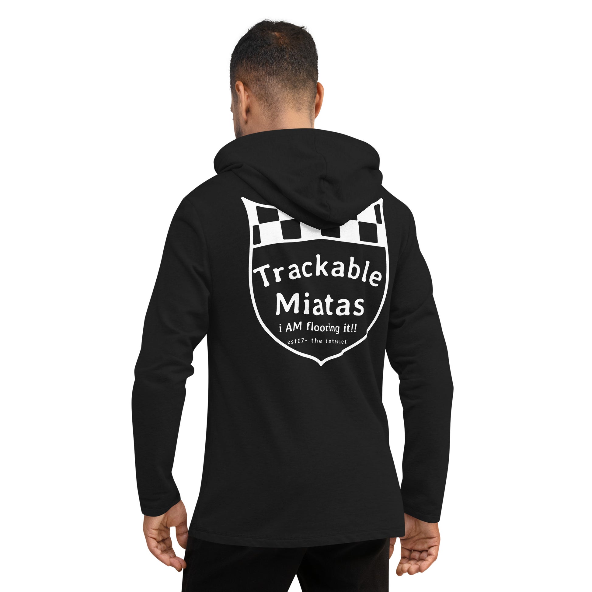 A person wearing the Warm Wang Gang pull over Hoodie by Nine Lives Racing, featuring a breathable design with a racing flag graphic and "Trackable Miatas" text on the back. Below this, additional text reads: "i AM flooring it!! – est?? the ‘inden’”. The individual is standing with their back to the camera, showcasing stylish layering fashion.