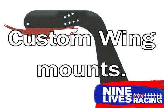 An illustrated image features sleek black Custom Wing Pylons on a white background with the text "Custom Wing Pylons" at the center. The bottom right corner showcases the "9livesracing" logo in blue and white, promising a top-tier powder coat upgrade.