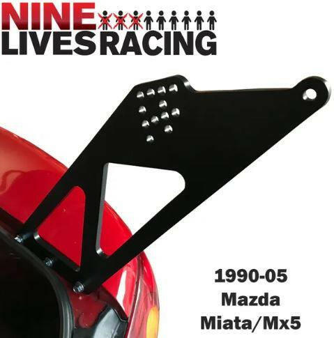 An aluminum bracket is mounted on the rear of a red car. The image features the text "9livesracing" at the top, with a group of stylized figures between "9" and "LIVES." Below the bracket, it reads "90-05 NA/NB Miata Mounts - Pylons Only.