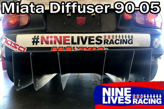 Rear view of a Miata car featuring the installed Miata Diffuser '90-05 NA/NB from 9livesracing. The bumper is adorned with several racing stickers, including "NINE LIVES RACING" and NASA. Text at the top reads, "Miata Diffuser '90-05 NA/NB." The 9livesracing logo is also overlaid in the bottom right corner.