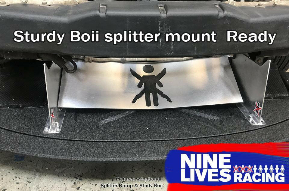 A Mazda Miata Splitter for 1990-05 NA/NB models, featuring the "Sturdy Boii" text and a stick figure stencil, is shown installed to enhance downforce. This splitter mount is part of the 9livesracing product line, as indicated by the logo in the bottom right corner.