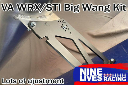 Close-up of a metal bracket with the text "Subaru Impreza / WRX / STI Big Wang kit 14-21 VA" at the top and "Lots of adjustment" at the bottom. The 9livesracing logo is in the lower right corner. This aluminum component appears to be part of a Subaru Impreza, designed for optimizing downforce in performance racing.